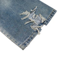 Vaqueros desgastados con borlas y campana