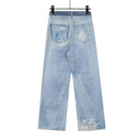 Jean évasé à pampilles effet usé