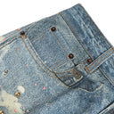 Jean évasé à pampilles effet usé