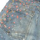 Jean évasé à pampilles effet usé