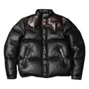 Black leather jacket with brown accents on a textured surface